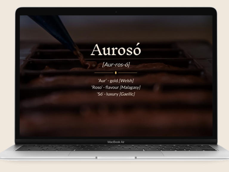 Laptop screen displaying a website named "Aurosó" with a dark background and text.