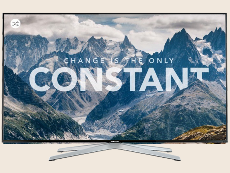 A television displaying the text "Change is the only constant" over a mountain landscape.