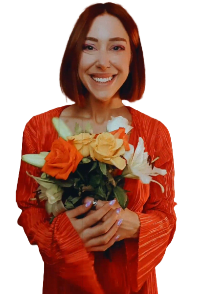 Smiling woman in a red dress holding a bouquet of orange and white flowers.